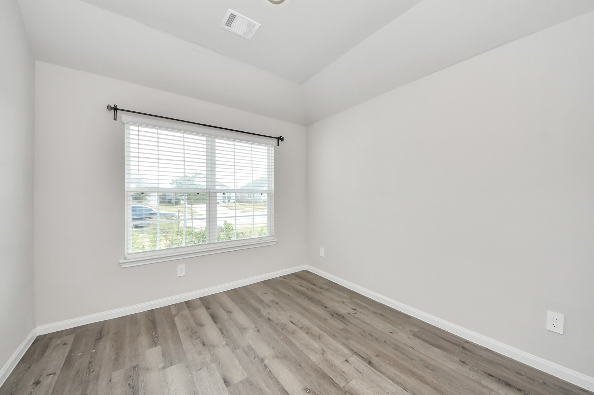 5626 Brooklyn Rose Drive Rosharon, TX 77583 - Photo 26 of 34 an empty room with wooden floor and windows