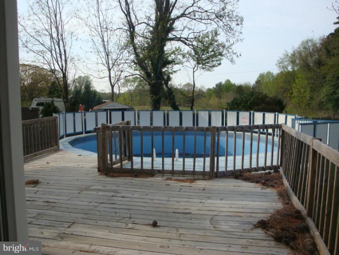954 Crystal Rock Road Lusby, MD 20657 - Photo 7 of 11 a view of balcony with wooden floor and fence