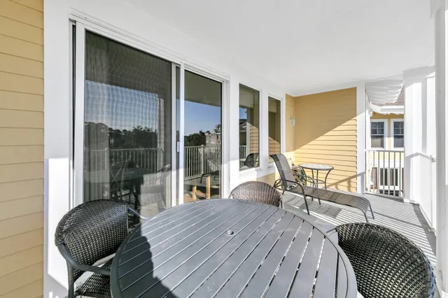 a balcony with wooden floor and furniture