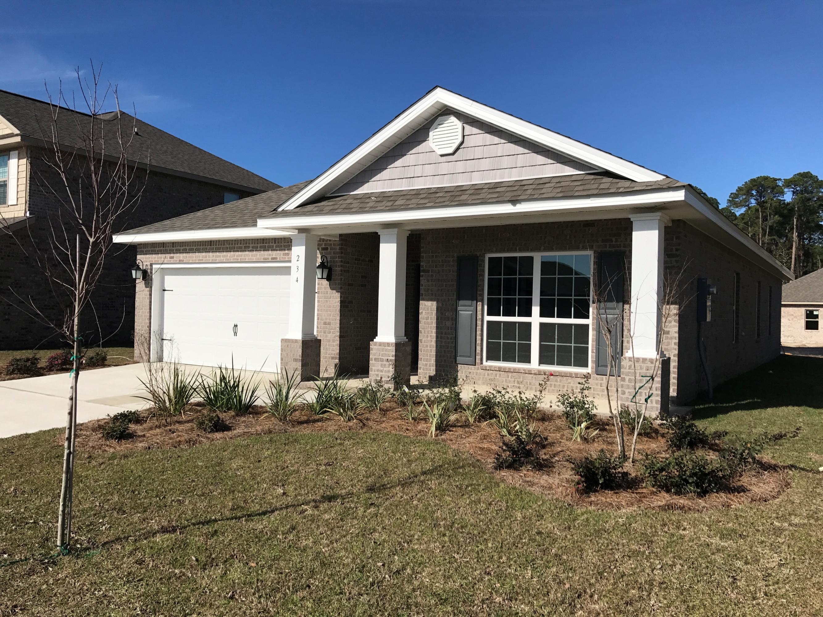 234 Pin Oak Loop Santa Rosa Beach, FL 32459 - Photo 1 of 22 a front view of a house with garden