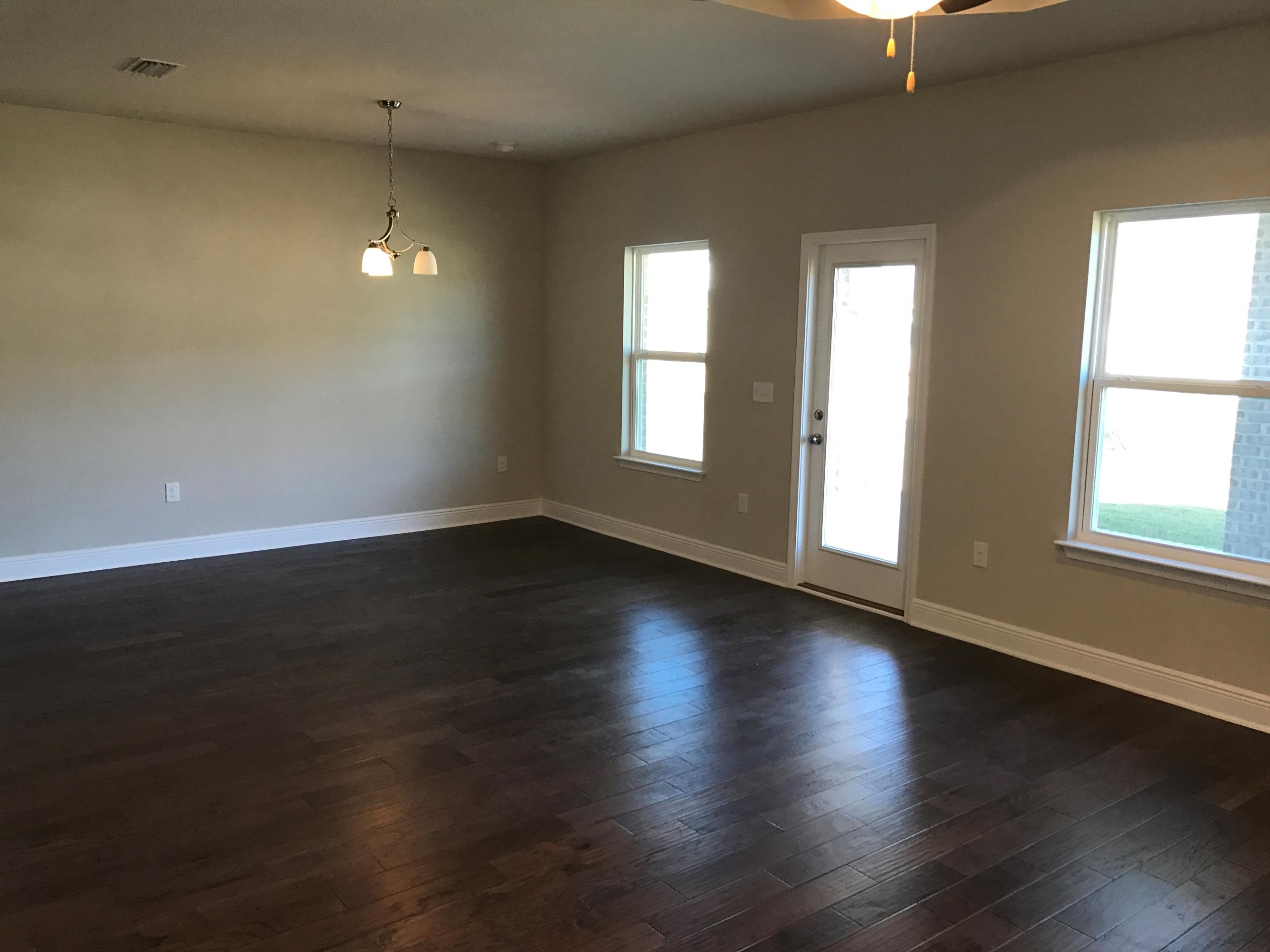 234 Pin Oak Loop Santa Rosa Beach, FL 32459 - Photo 12 of 22 an empty room with wooden floor and windows