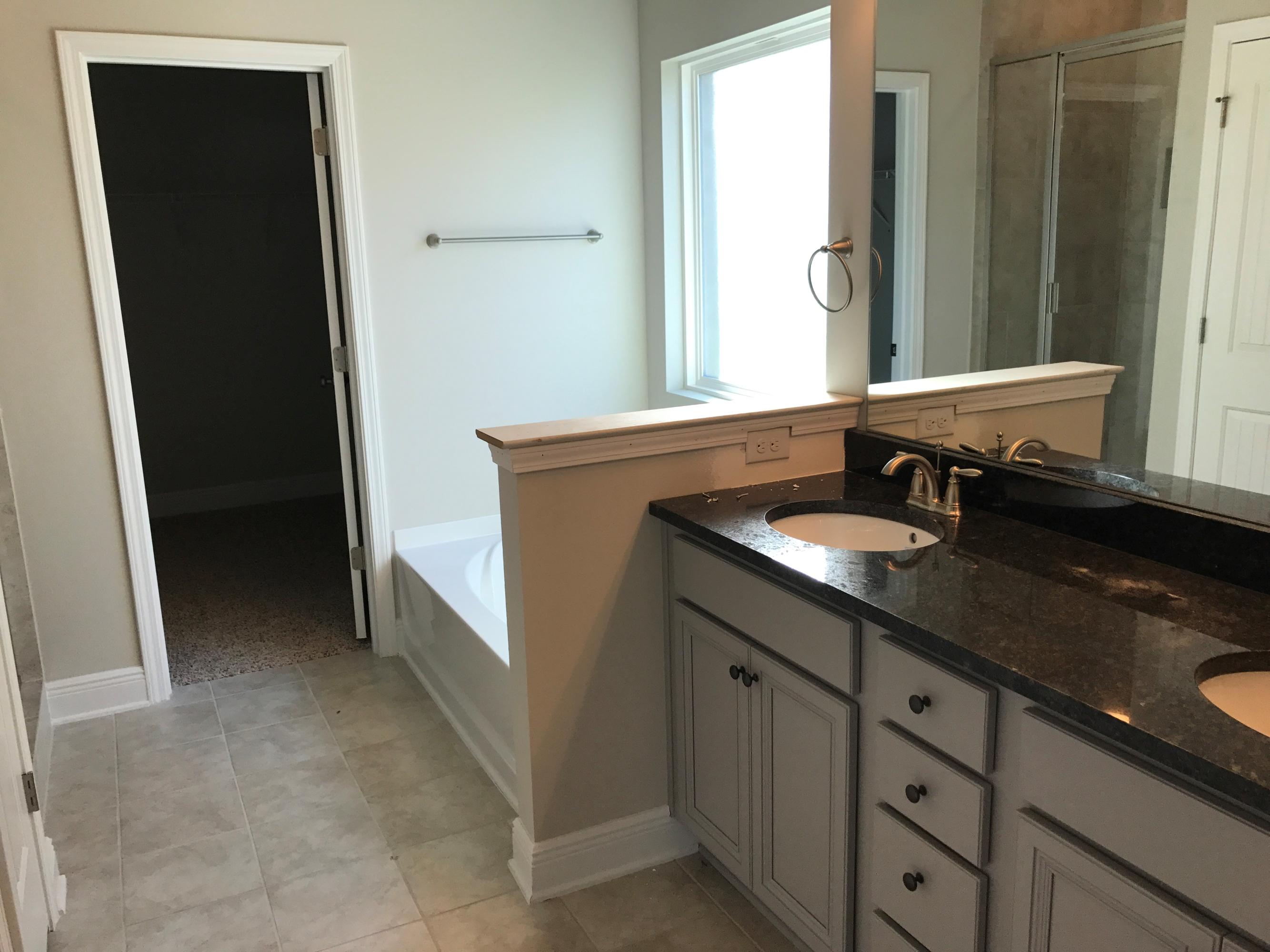 234 Pin Oak Loop Santa Rosa Beach, FL 32459 - Photo 14 of 22 a bathroom with a sink and a mirror