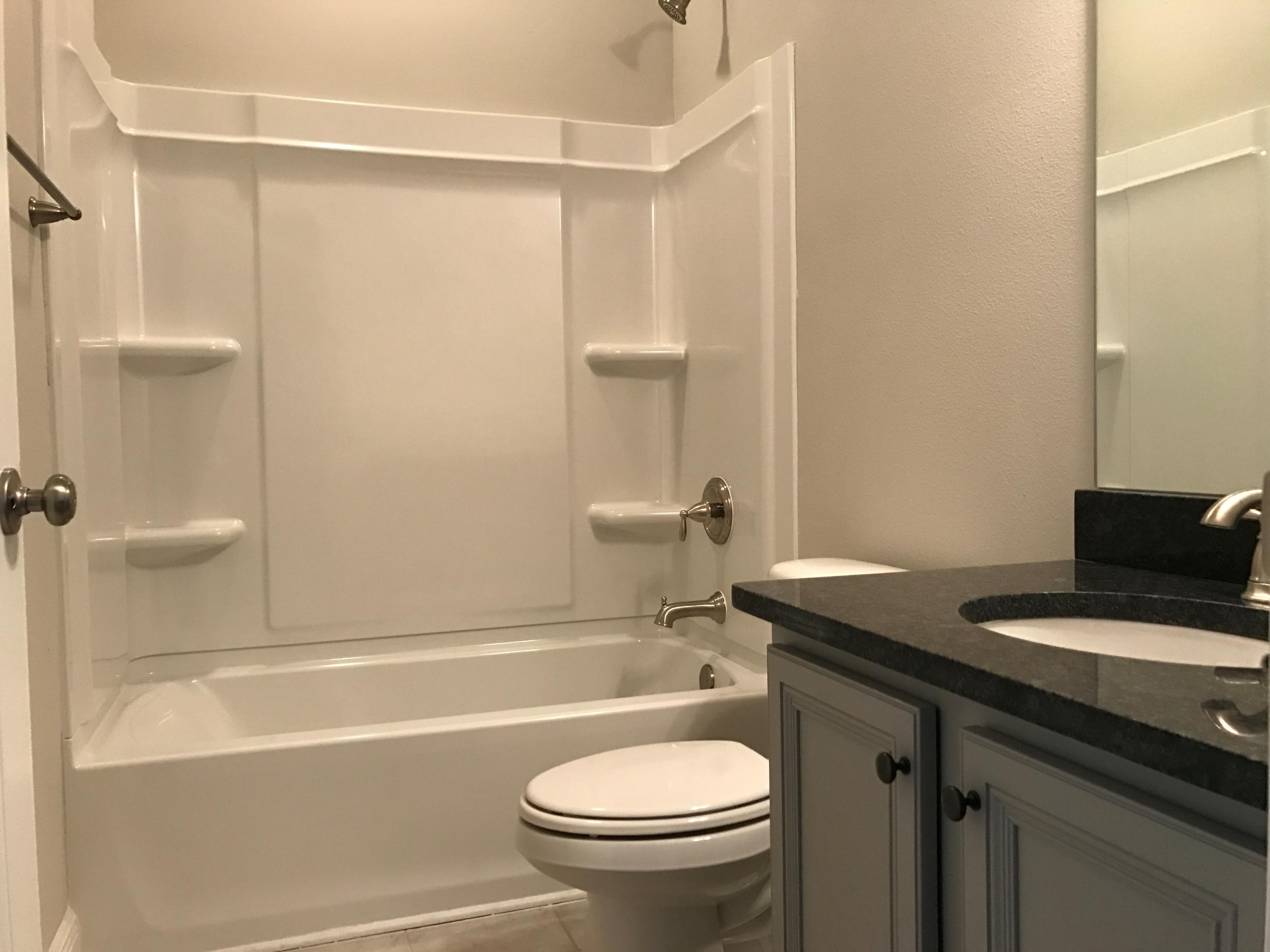 234 Pin Oak Loop Santa Rosa Beach, FL 32459 - Photo 17 of 22 a bathroom with a granite countertop sink toilet and shower