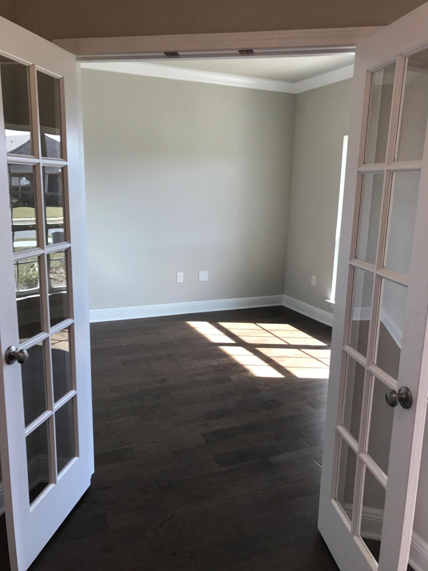 234 Pin Oak Loop Santa Rosa Beach, FL 32459 - Photo 3 of 22 a view of an empty room with wooden floor and a window