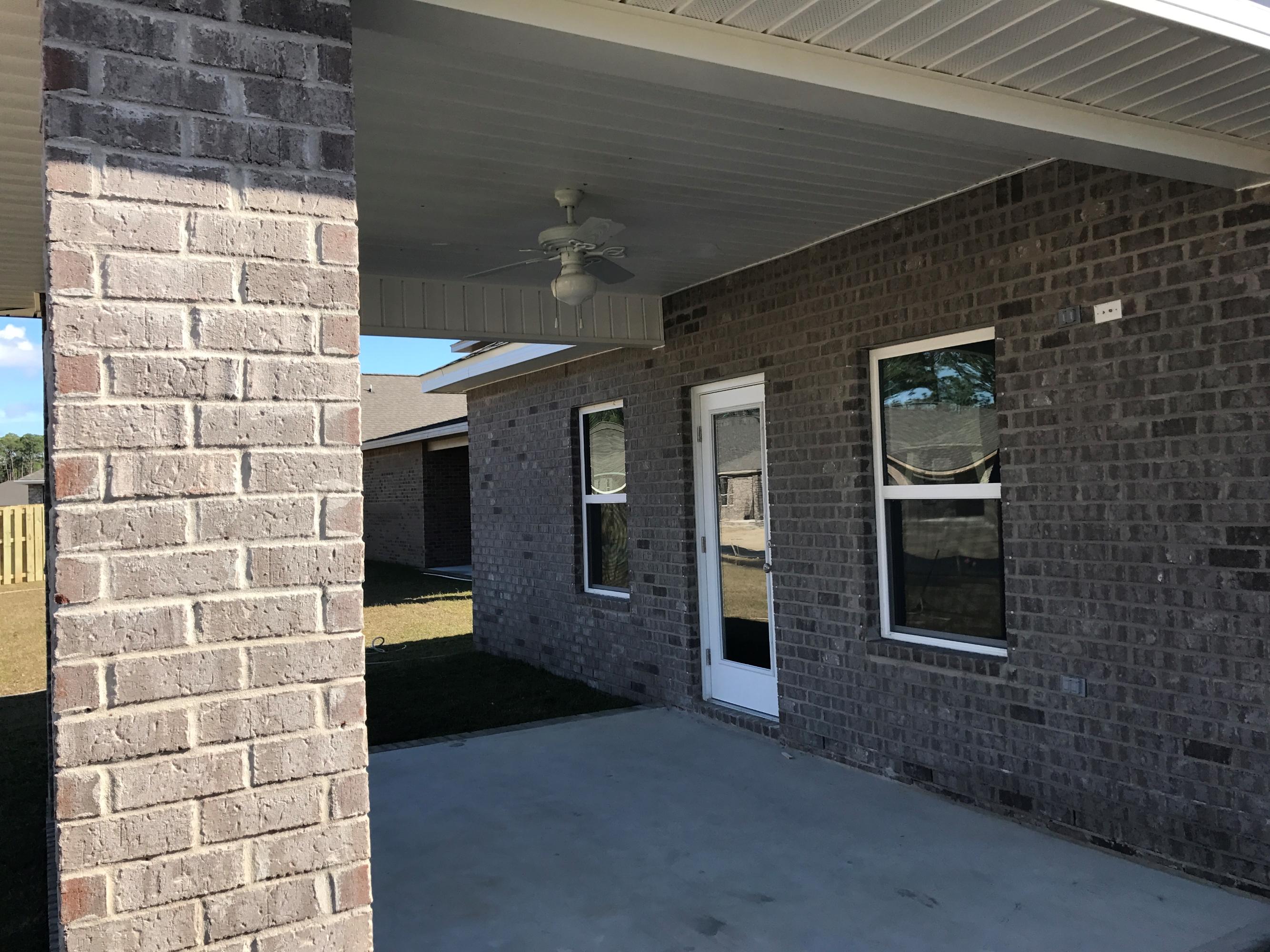 234 Pin Oak Loop Santa Rosa Beach, FL 32459 - Photo 21 of 22 a view of a brick house with an outdoor space