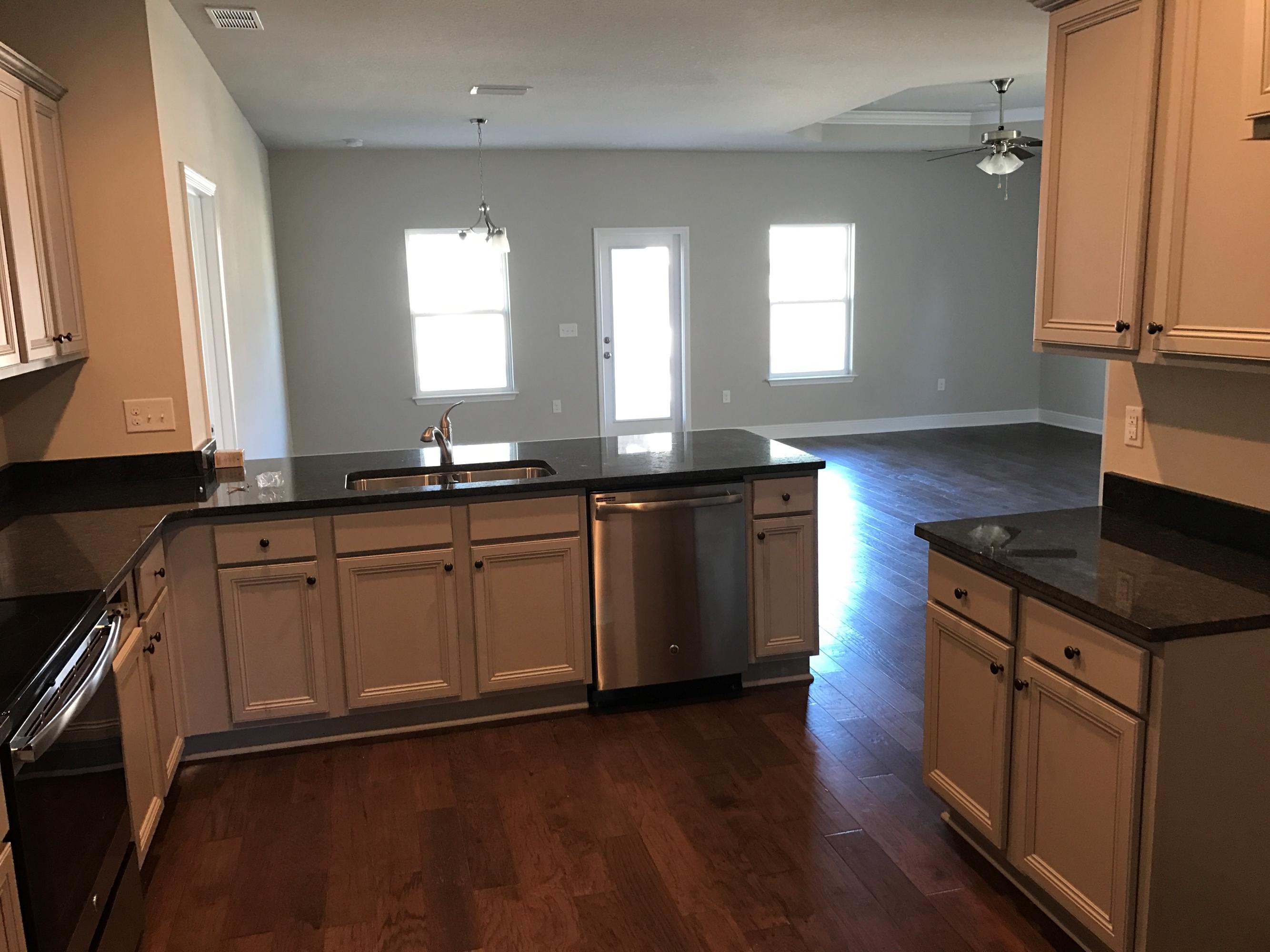 234 Pin Oak Loop Santa Rosa Beach, FL 32459 - Photo 6 of 22 a kitchen with a sink stove and cabinets