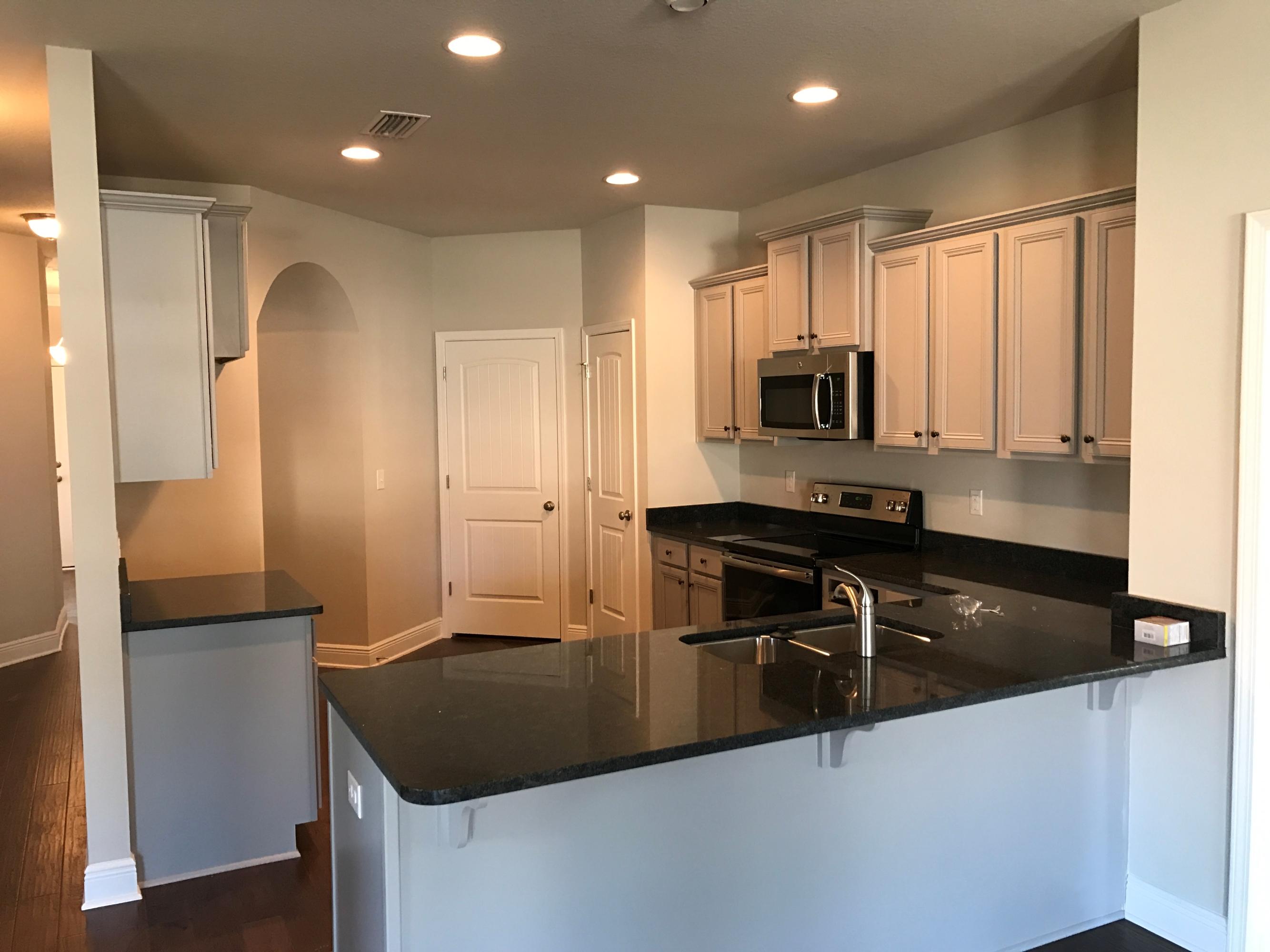 234 Pin Oak Loop Santa Rosa Beach, FL 32459 - Photo 7 of 22 a kitchen with kitchen island a counter space and a sink