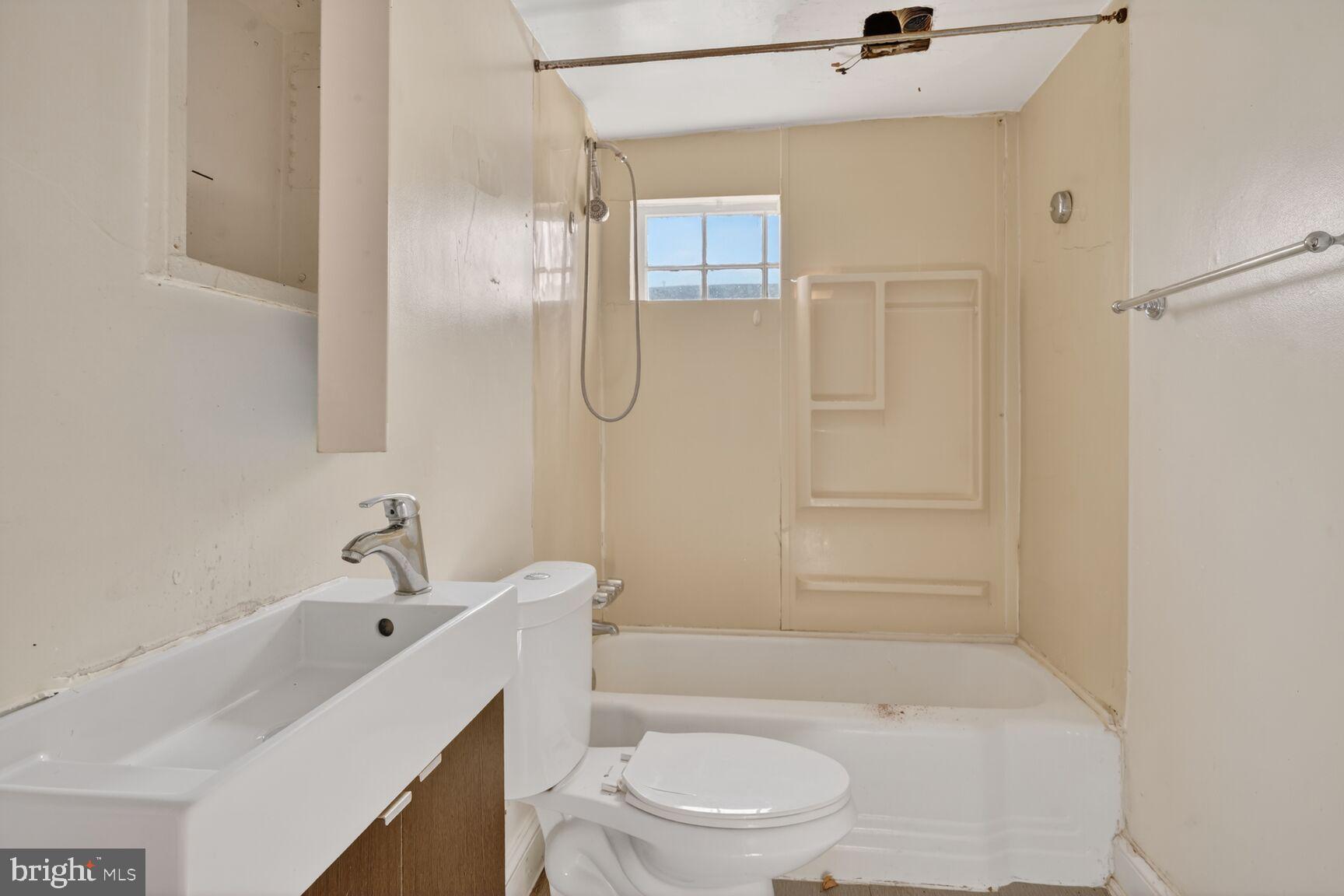 1701 6th Street Northwest Washington, DC 20001 - Photo 14 of 23 a bathroom with a sink a toilet and shower