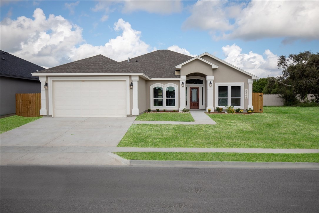 a front view of a house with a yard and garage