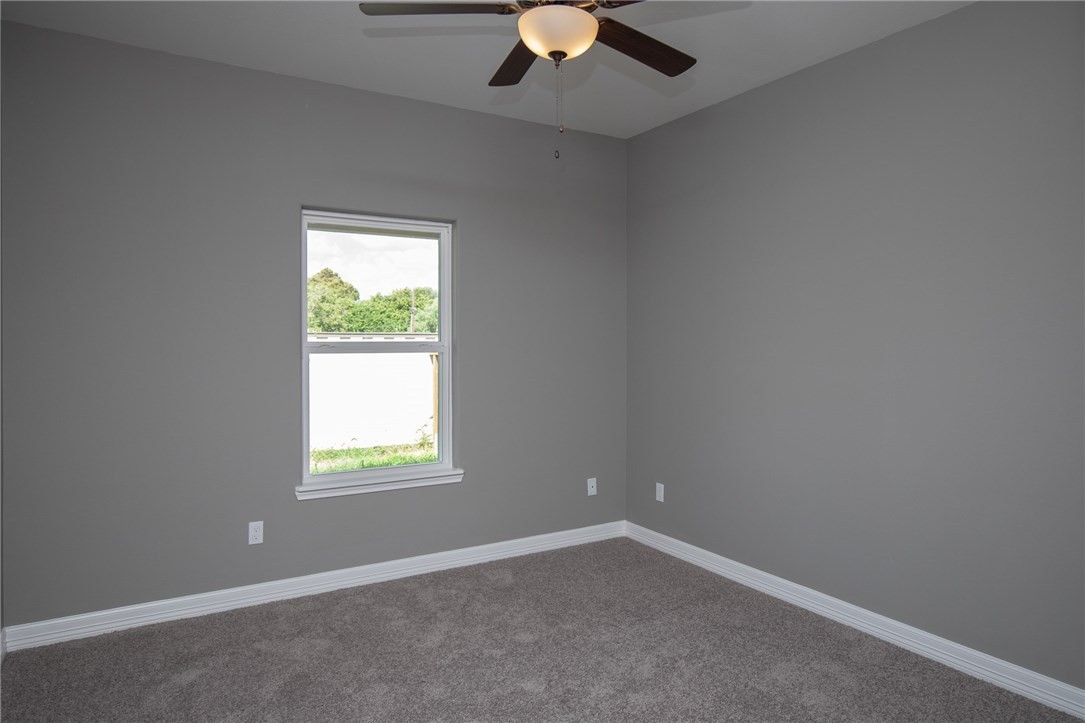 3049 St Eustatius Corpus Christi, TX 78418 - Photo 5 of 8 an empty room with a window and a fan