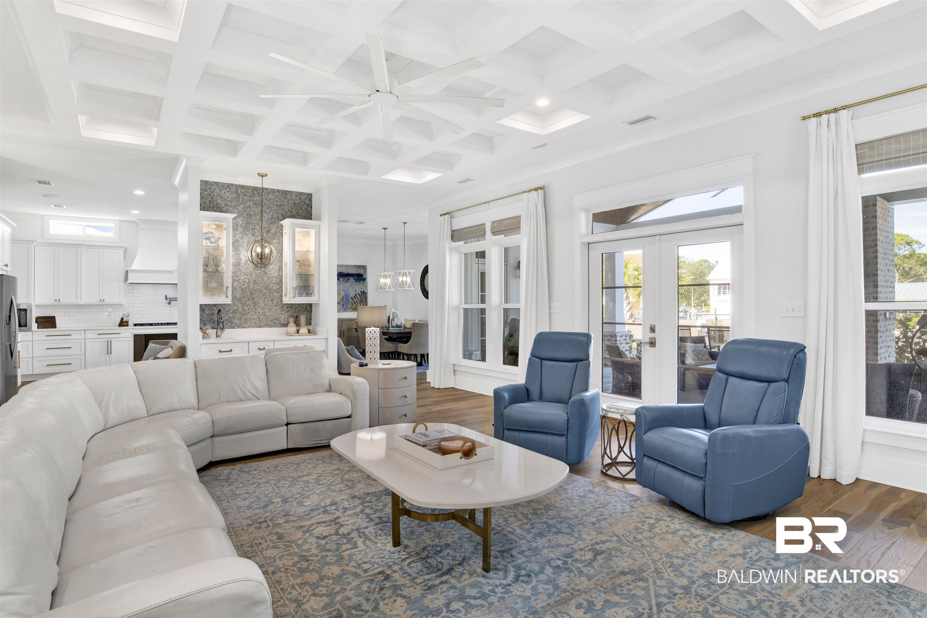 32937 River Road Orange Beach, AL 36561 - Photo 8 of 42 Living room with beam ceiling, french doors, coffered ceiling, dark hardwood / wood-style floors, and ceiling fan with notable chandelier