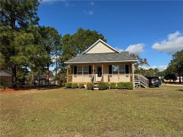 a front view of a house with a garden and yard