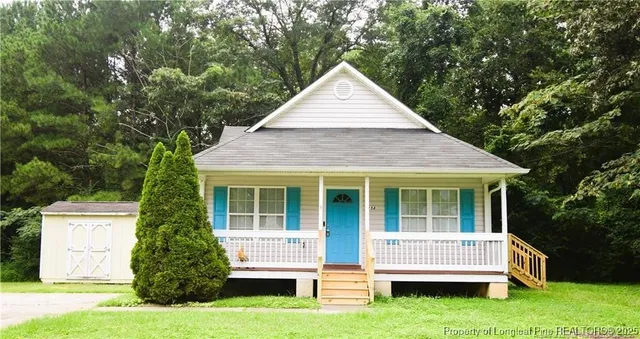 a view of house with yard