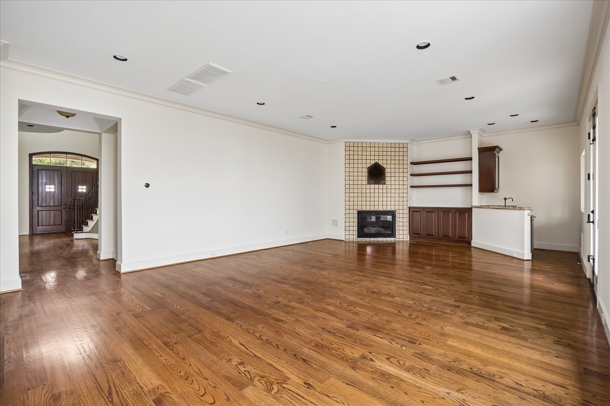 2246 Branard Street Houston, TX 77098 - Photo 17 of 40 This view of the family family room highlights the hardwood floors, custom built-ins, and effortless flow to the foyer and adjacent entertaining spaces.