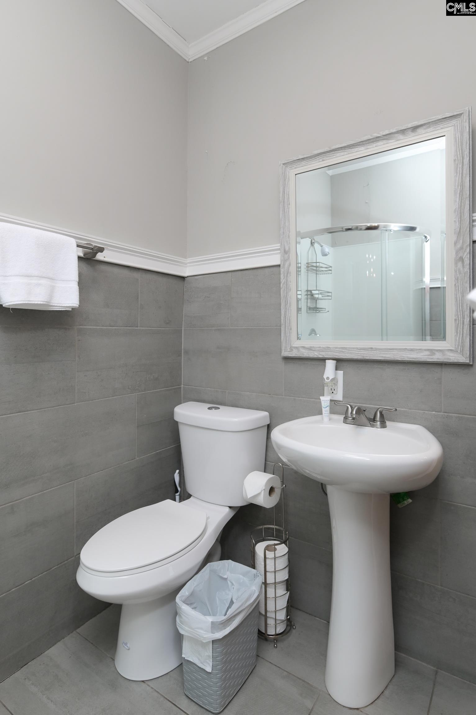 2227 Bull Street Columbia, SC 29201 - Photo 28 of 38 a bathroom with a toilet sink and mirror