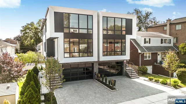 a view of a brick house with a chairs and table in a patio