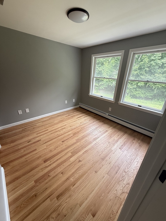 295 Frenchtown Road East Greenwich, RI 02818 - Photo 11 of 26 an empty room with wooden floor and windows
