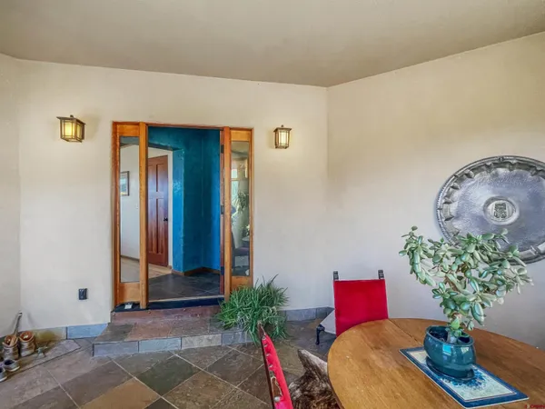 a living room with furniture and flowers