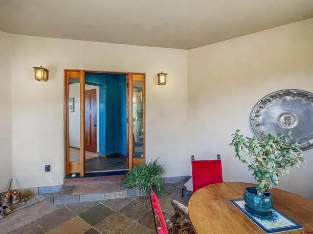a living room with furniture and flowers