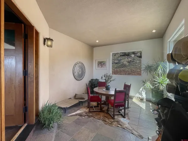 a living room with furniture a rug and a wall painting