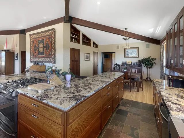 a kitchen with stainless steel appliances granite countertop a stove and a sink