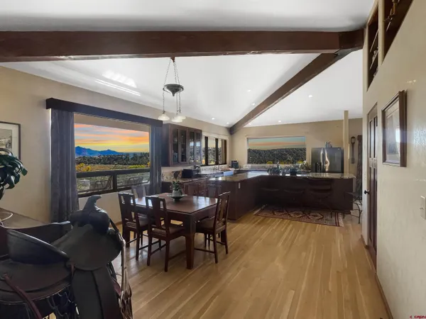 a view of a dining room with furniture window and wooden floor