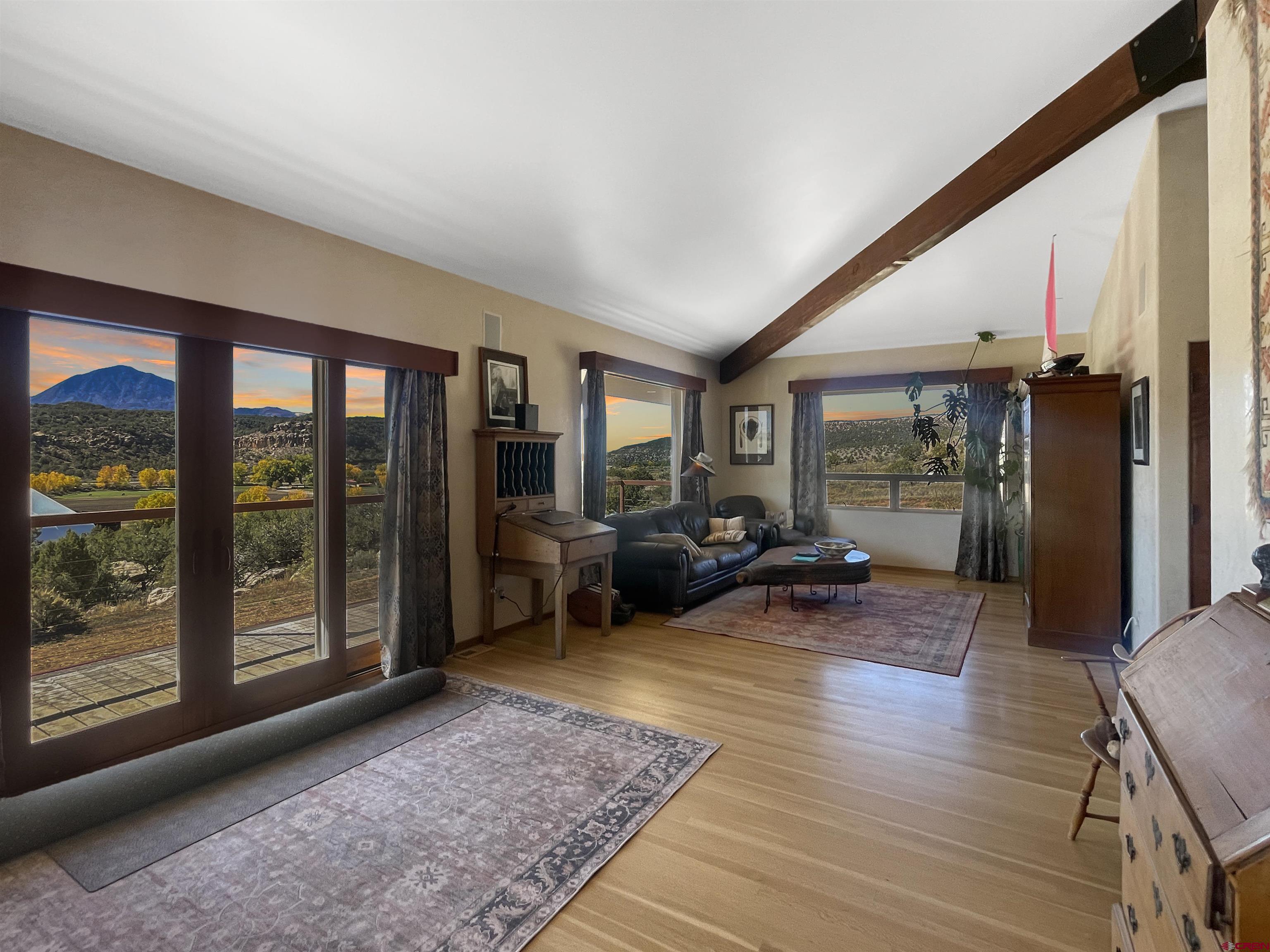 20615 Rd G Cortez, CO 81321 - Photo 31 of 43 a living room with furniture floor to ceiling window and wooden floor