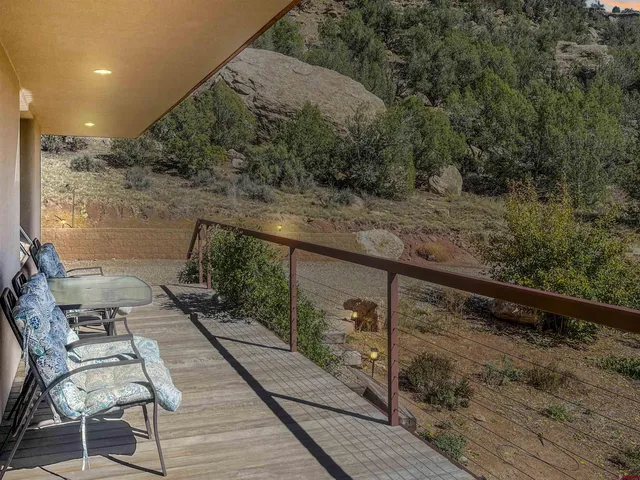 a view of balcony with wooden floor and seating space