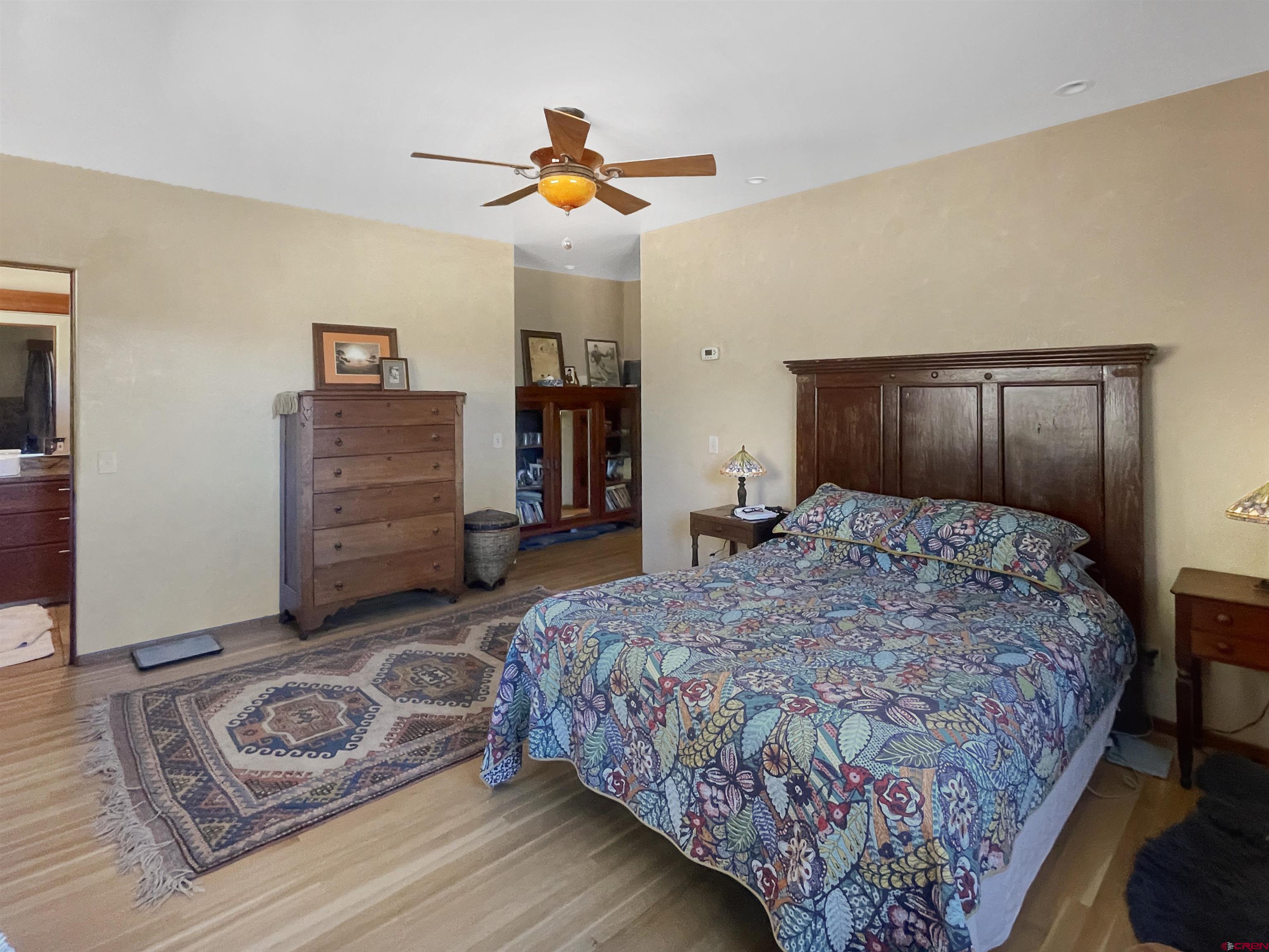 20615 Rd G Cortez, CO 81321 - Photo 41 of 43 a bedroom with a bed and a chandelier