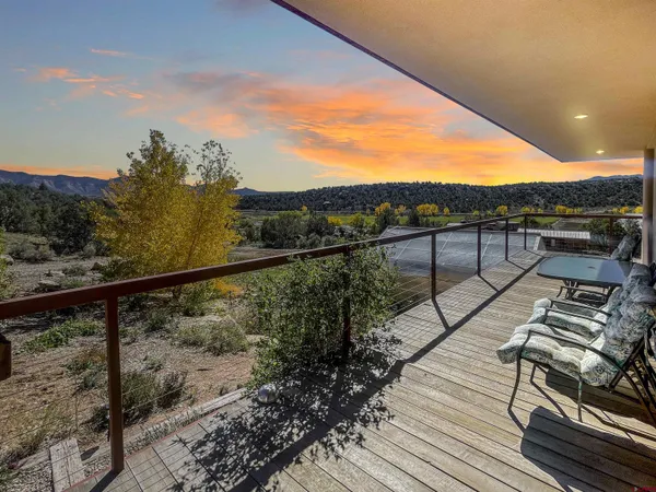 a view of a balcony with wooden floor and city view