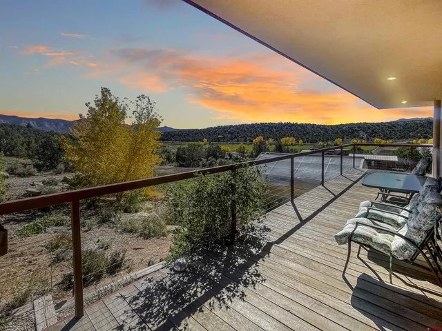 a view of a balcony with wooden floor and city view