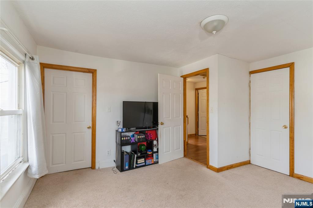 656 Scotland Road Orange, NJ 07050 - Photo 11 of 23 a view of a livingroom with a flat screen tv and a window