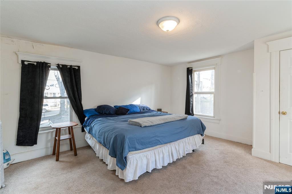 656 Scotland Road Orange, NJ 07050 - Photo 15 of 23 a bedroom with a bed lamp and a window