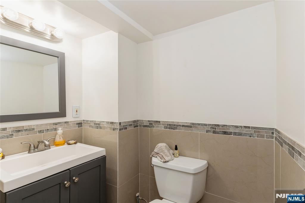 656 Scotland Road Orange, NJ 07050 - Photo 20 of 23 a bathroom with a sink a toilet and mirror