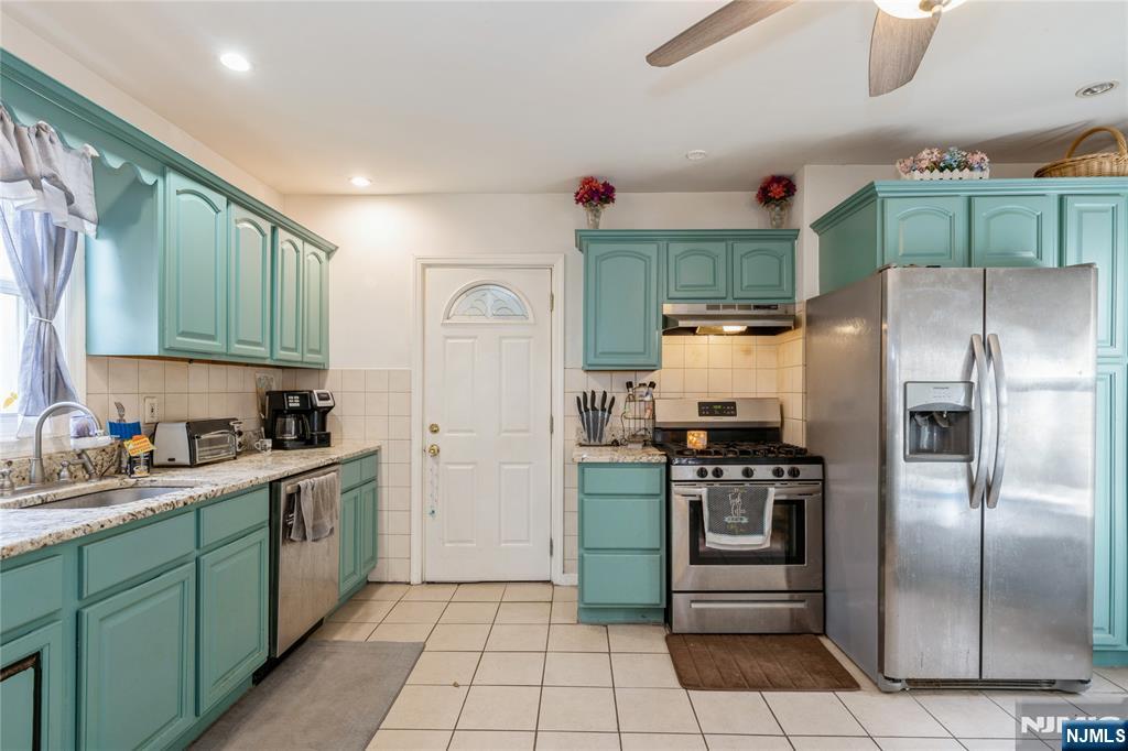 656 Scotland Road Orange, NJ 07050 - Photo 2 of 23 a kitchen with stainless steel appliances granite countertop a refrigerator and a stove