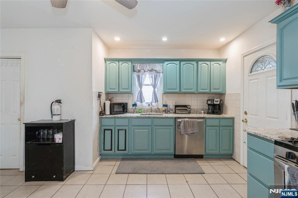 656 Scotland Road Orange, NJ 07050 - Photo 3 of 23 a kitchen with stainless steel appliances granite countertop a refrigerator and a stove top oven