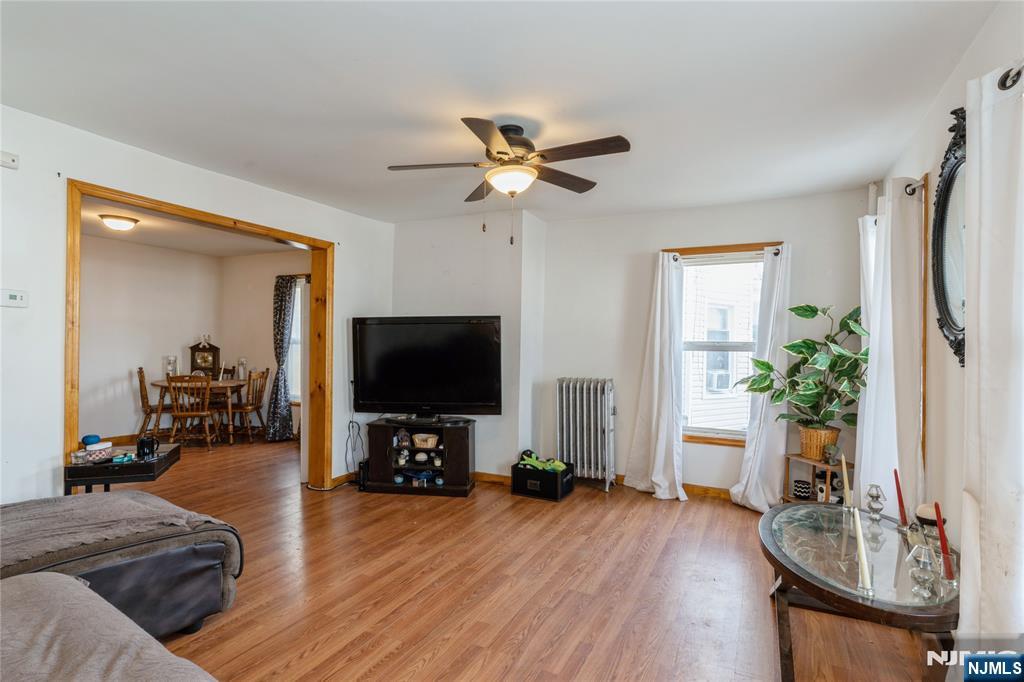656 Scotland Road Orange, NJ 07050 - Photo 9 of 23 a living room with furniture and a flat screen tv