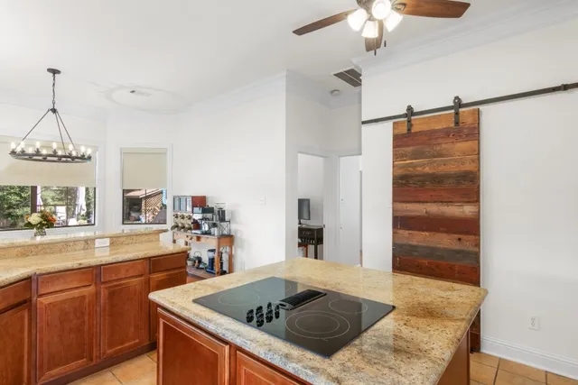 a kitchen that has a lot of cabinets and wooden floor