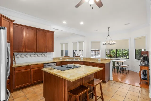a kitchen with a stove a sink a table and chairs