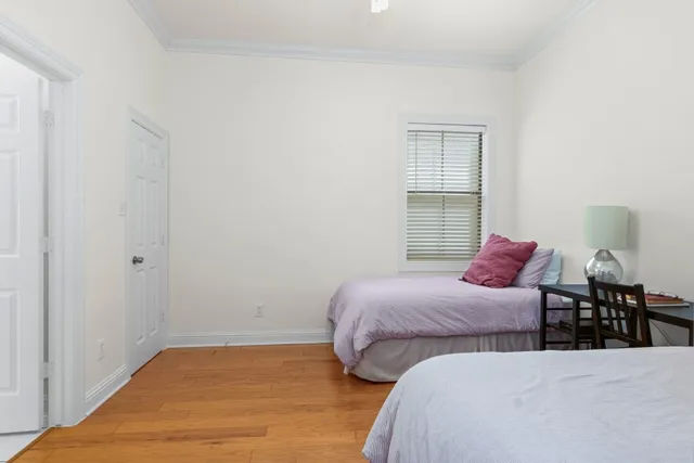 a bedroom with two beds and a window