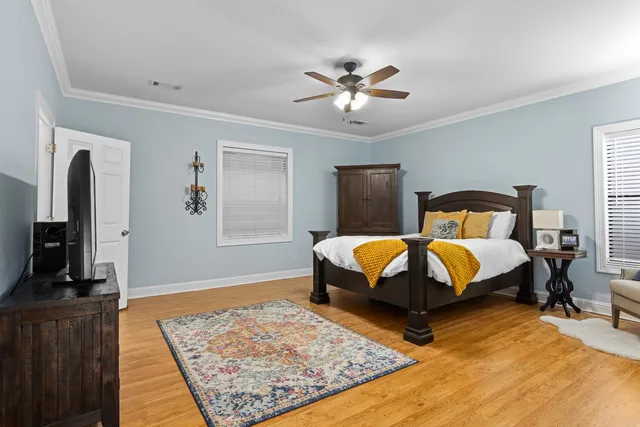 a bedroom with a large bed and a flat screen tv
