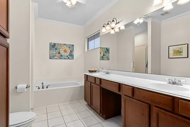 a bathroom with a tub a sink and mirror