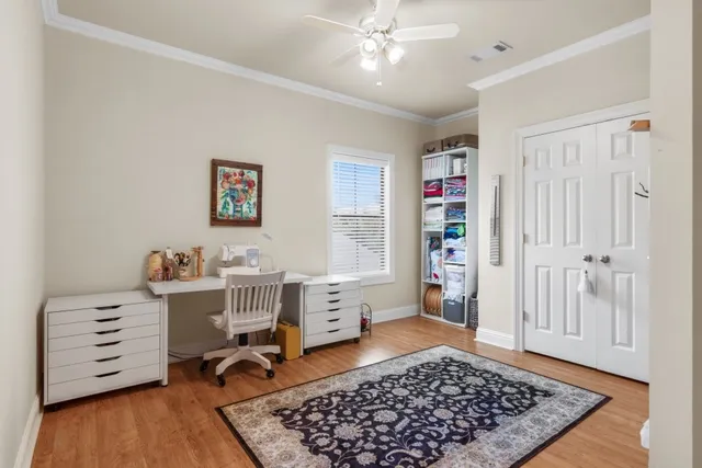 a view of a workspace with furniture and wooden floor
