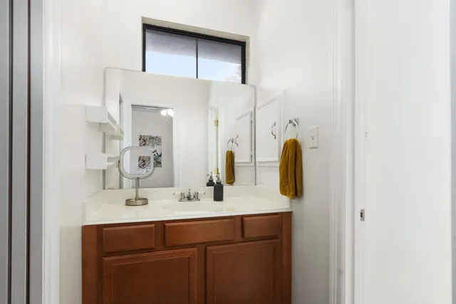 a bathroom with a double vanity sink and a mirror