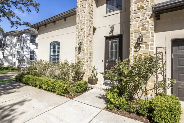 a view of a white house with many windows