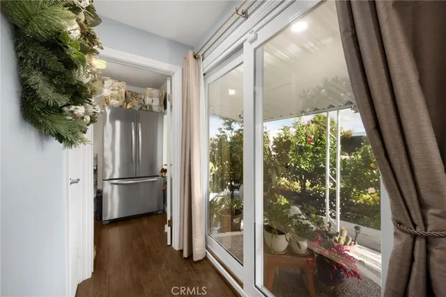 a view of a walk in closet with wooden floor