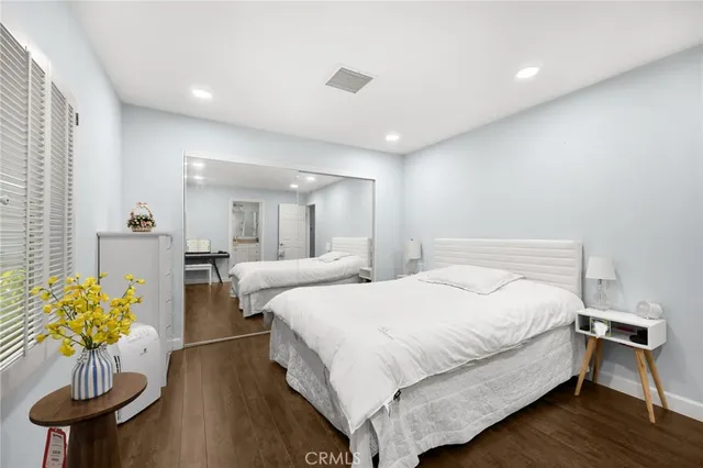 a bedroom with bed and a chandelier