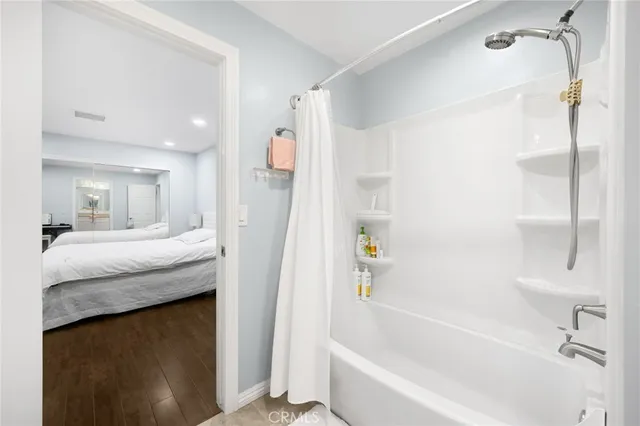 a bathroom with a granite countertop sink mirror toilet and bathtub