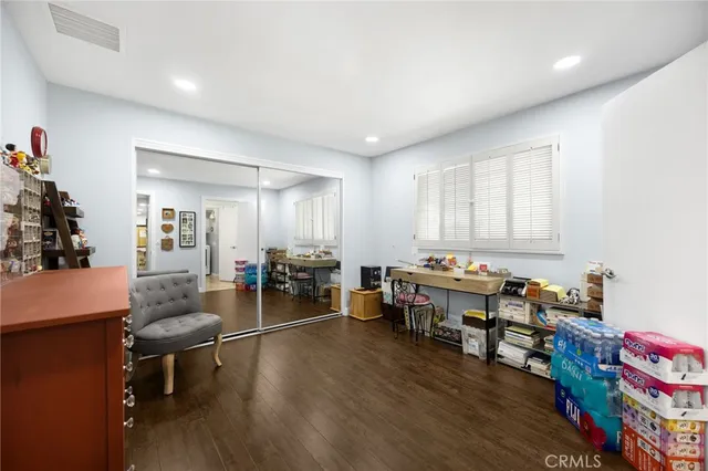 a playing room with furniture and a wooden floor