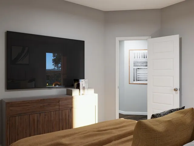 a bedroom with a large bed and a window